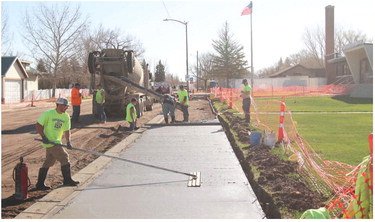 THE NEW ROAD AND SIDEWALK ….